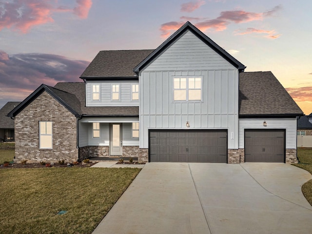 view of front of home featuring a garage and a lawn