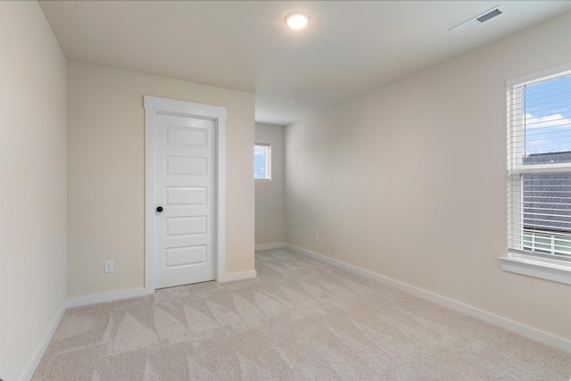 spare room with light colored carpet