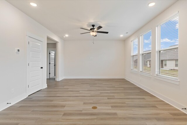 empty room featuring light hardwood / wood-style flooring and ceiling fan