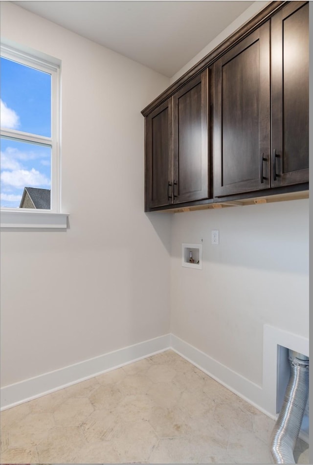 laundry area with washer hookup and cabinets