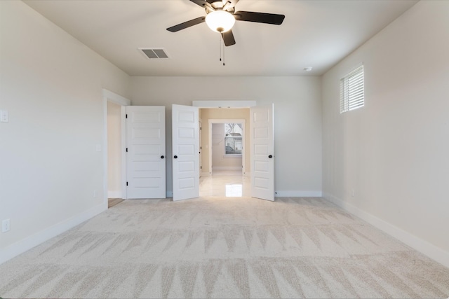 carpeted empty room with ceiling fan