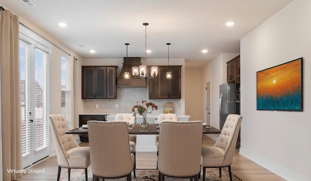 dining room featuring a chandelier and light hardwood / wood-style flooring