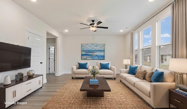 living room featuring hardwood / wood-style flooring and ceiling fan