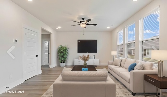 living room with ceiling fan and hardwood / wood-style floors