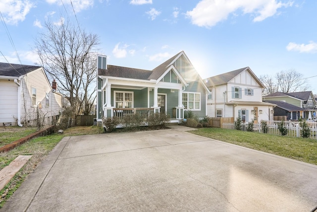 view of front of property with a porch and a front yard