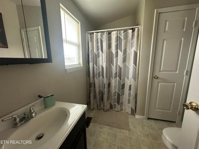 bathroom with vanity, curtained shower, vaulted ceiling, and toilet