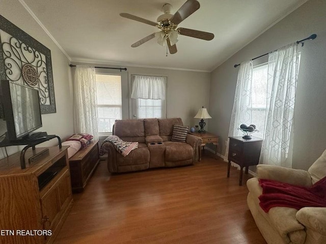 living room featuring crown molding, hardwood / wood-style flooring, vaulted ceiling, and a wealth of natural light