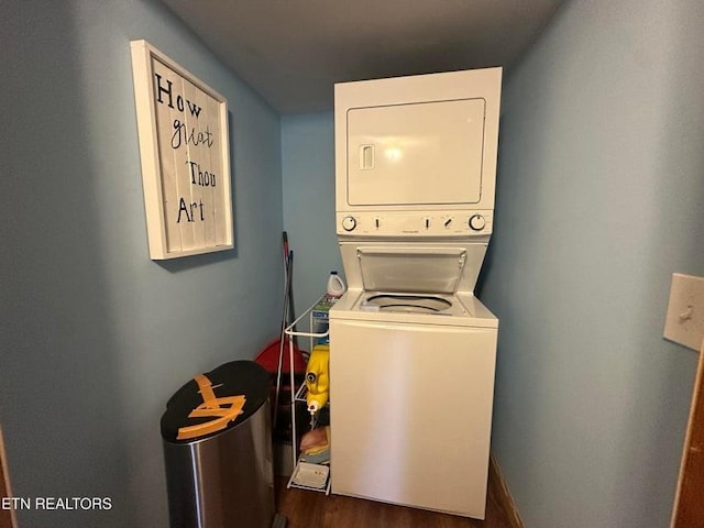 laundry room with dark wood-type flooring and stacked washing maching and dryer