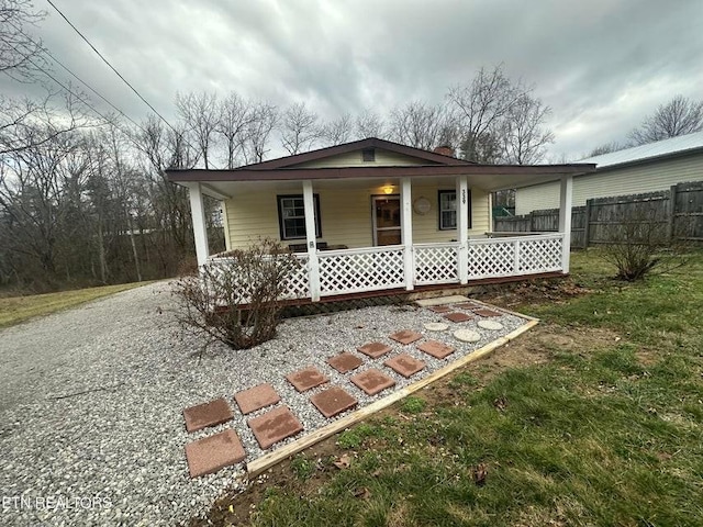 view of front of home featuring covered porch and a front yard