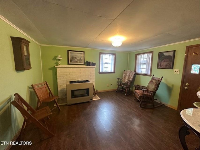 living area with crown molding, dark hardwood / wood-style floors, and a brick fireplace