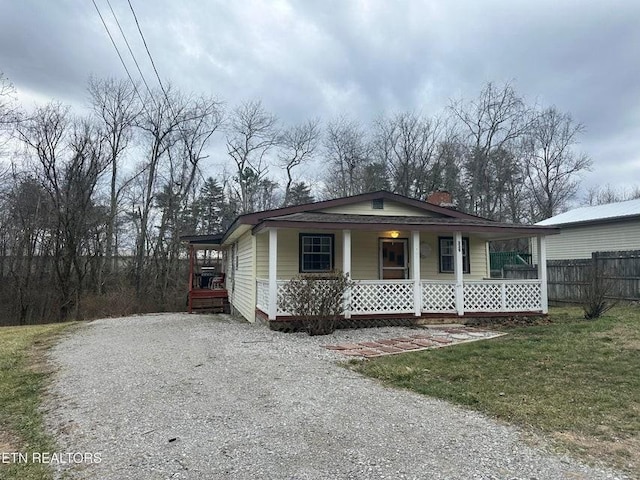 view of front of house with covered porch and a front yard