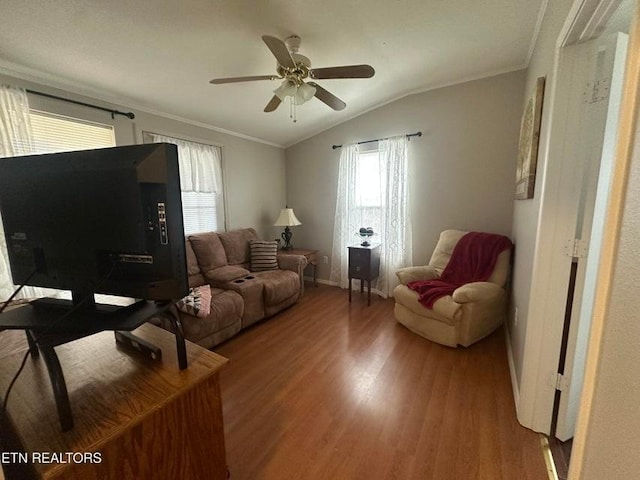 living room with ceiling fan, lofted ceiling, ornamental molding, and hardwood / wood-style floors