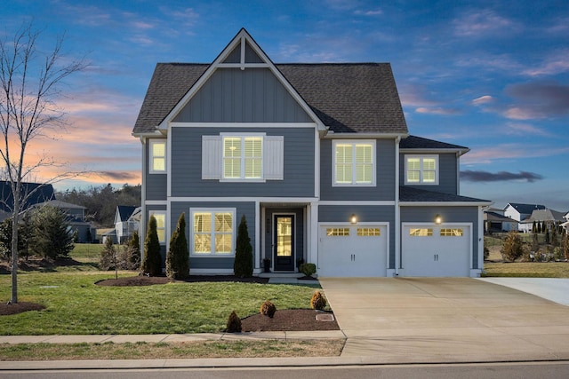 view of front of home with a shingled roof, a lawn, concrete driveway, an attached garage, and board and batten siding