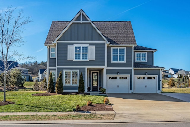 view of front facade with driveway, roof with shingles, an attached garage, a front lawn, and board and batten siding