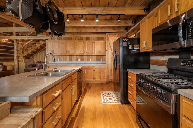 kitchen with appliances with stainless steel finishes, sink, wood ceiling, and light hardwood / wood-style floors