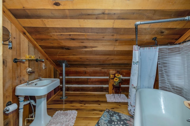 bathroom with wooden ceiling, lofted ceiling, and wood walls