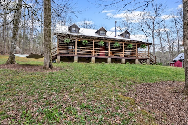 back of house with a lawn