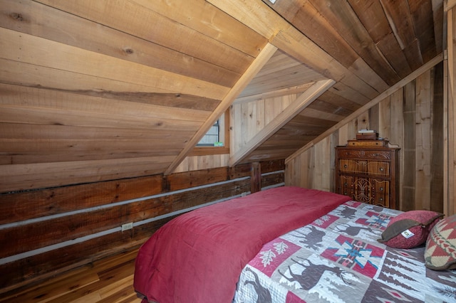 bedroom with wooden walls, wooden ceiling, and vaulted ceiling