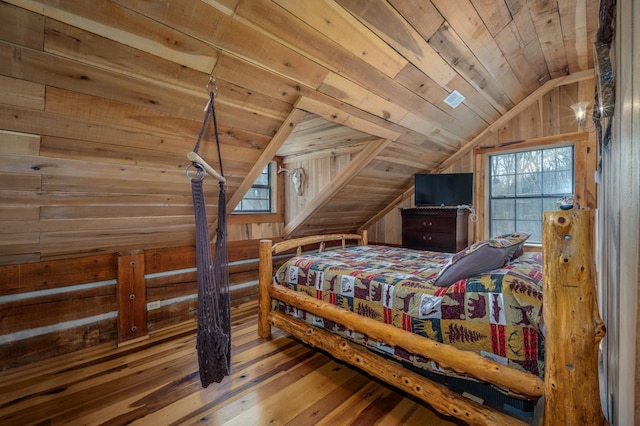 bedroom featuring wood ceiling, lofted ceiling, wooden walls, and hardwood / wood-style floors