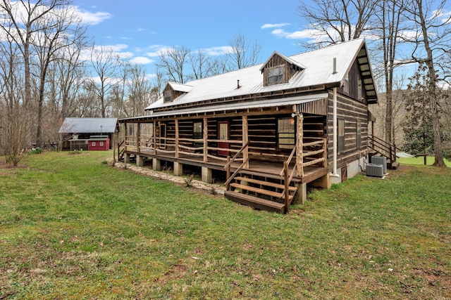 back of house featuring central AC and a yard