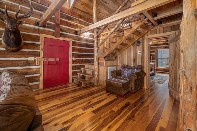 interior space with dark wood-type flooring and wood walls