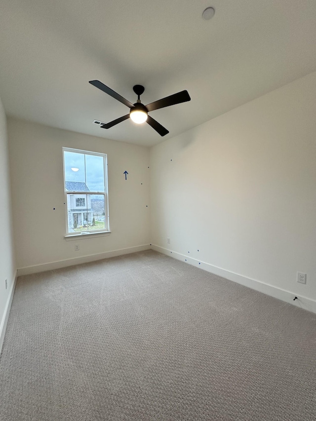 spare room featuring carpet floors and ceiling fan