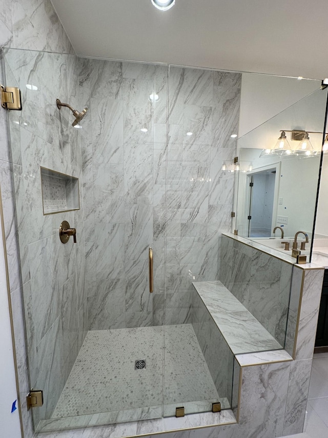 bathroom featuring walk in shower and vanity