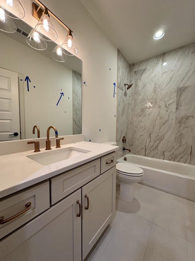 full bathroom featuring vanity, toilet, tiled shower / bath combo, and tile patterned flooring