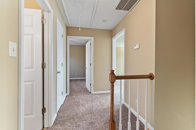 corridor featuring light colored carpet