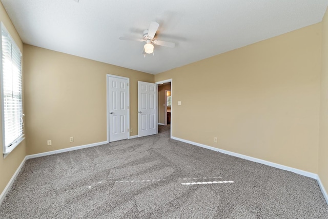 unfurnished bedroom featuring carpet floors and ceiling fan