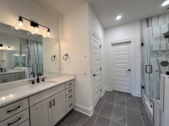 bathroom with vanity and a shower with door