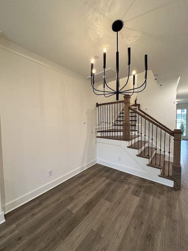 interior space featuring crown molding, hardwood / wood-style floors, and a chandelier