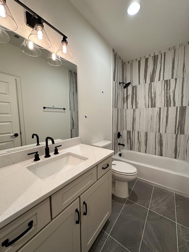 full bathroom featuring vanity, tiled shower / bath combo, and toilet