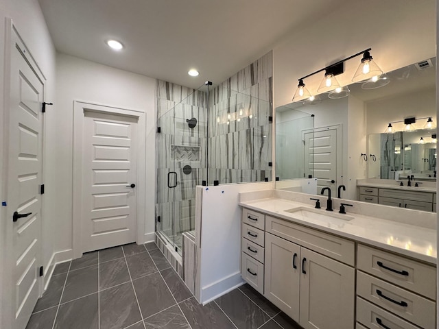 bathroom featuring a shower with door and vanity