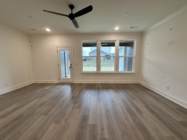 spare room with crown molding, dark hardwood / wood-style floors, and ceiling fan