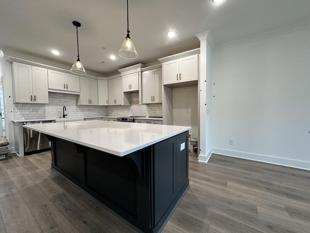 kitchen featuring a kitchen island, dark hardwood / wood-style floors, decorative light fixtures, white cabinetry, and stainless steel dishwasher