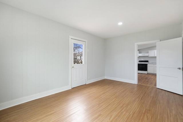 spare room with light hardwood / wood-style flooring