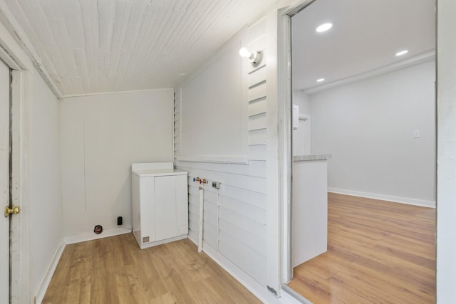 laundry area featuring wood ceiling and light hardwood / wood-style floors