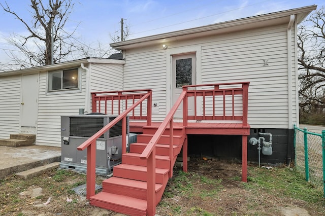 back of property with a wooden deck and central air condition unit