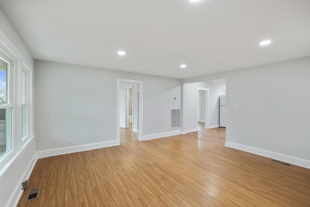 unfurnished room with light hardwood / wood-style floors