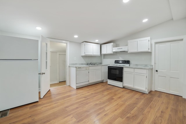 kitchen with sink, white cabinetry, vaulted ceiling, light wood-type flooring, and white appliances