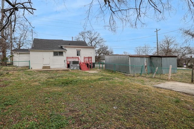 rear view of property with a yard