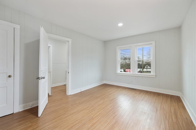 unfurnished room with light hardwood / wood-style flooring