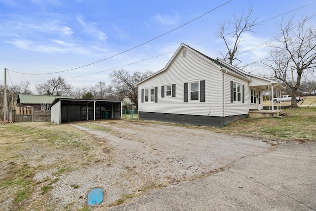 view of property exterior featuring a carport and covered porch