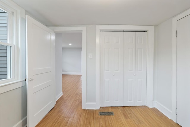 interior space with light hardwood / wood-style floors and a closet