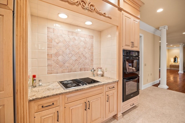 kitchen with stovetop, backsplash, black double oven, and ornate columns