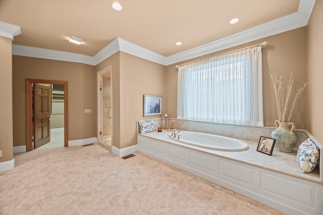 bathroom featuring ornamental molding and separate shower and tub