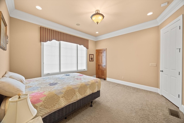 bedroom with ornamental molding and carpet floors