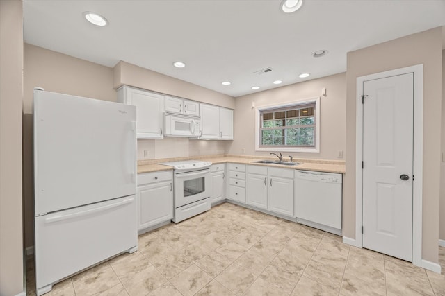 kitchen with white cabinetry, white appliances, and sink