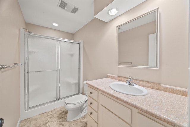 bathroom with a shower with door, vanity, and toilet